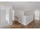 Hallway with hardwood and doorways leading to bedrooms and living spaces at 134 Black Walnut Dr # 205, Garner, NC 27529