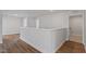 Hallway with hardwood floors leading to a bathroom at 134 Black Walnut Dr # 205, Garner, NC 27529