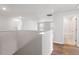 Bright hallway with hardwood floors, white walls, and access to a bathroom at 134 Black Walnut Dr # 205, Garner, NC 27529