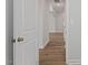 Bright hallway showcasing wood-look floors and multiple doorways leading to other rooms at 134 Black Walnut Dr # 205, Garner, NC 27529