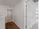 Bright hallway featuring wood-look flooring and white trim, leading to various rooms at 134 Black Walnut Dr # 205, Garner, NC 27529