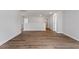 Wide hallway with hardwood flooring, multiple doorways, and neutral paint at 134 Black Walnut Dr # 205, Garner, NC 27529