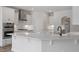 Spacious kitchen with white cabinets, stainless steel appliances, and a large island at 134 Black Walnut Dr # 205, Garner, NC 27529