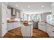 Modern white kitchen features a center island, stainless appliances, and ample natural light at 134 Black Walnut Dr # 205, Garner, NC 27529