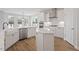Bright kitchen featuring white cabinets, stainless steel appliances, and a spacious center island at 134 Black Walnut Dr # 205, Garner, NC 27529