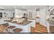 Bright, white kitchen boasts a large island, stainless steel appliances, and stylish wood floors at 134 Black Walnut Dr # 205, Garner, NC 27529