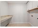 Functional laundry room with storage cabinets and a granite-look folding countertop at 134 Black Walnut Dr # 205, Garner, NC 27529