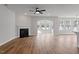 Bright living room with wood floors, fireplace, and arched opening leading to a sunroom with multiple windows at 134 Black Walnut Dr # 205, Garner, NC 27529