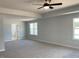 Large main bedroom featuring carpeted floor, ceiling fan, and plenty of natural light from the windows at 134 Black Walnut Dr # 205, Garner, NC 27529