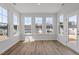 Sunroom featuring wood-look flooring and multiple windows offering a view of the neighborhood at 134 Black Walnut Dr # 205, Garner, NC 27529