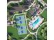 Aerial view showcasing community amenities, including a pool, pickleball courts, parking, and green spaces at 208 Regency Ridge Dr, Holly Springs, NC 27540