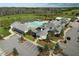 Aerial view of community center with pool, parking, golf course and pond at 208 Regency Ridge Dr, Holly Springs, NC 27540