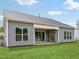 Exterior of home with an outdoor stone fireplace and sliding glass doors at 208 Regency Ridge Dr, Holly Springs, NC 27540