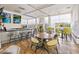 Community clubhouse bar area with tables, stools, windows, and modern lighting fixtures at 208 Regency Ridge Dr, Holly Springs, NC 27540