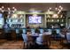 Upscale bar area with plentiful seating, well-stocked shelves, and modern lighting fixtures at 208 Regency Ridge Dr, Holly Springs, NC 27540