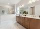 Modern bathroom with double vanity, wood cabinets, large mirror, and marble walk-in shower at 208 Regency Ridge Dr, Holly Springs, NC 27540