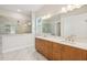 Modern bathroom with double vanity, granite countertop, and walk-in shower with clear glass doors at 208 Regency Ridge Dr, Holly Springs, NC 27540