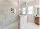 Modern bathroom with a large glass shower featuring marble tile, rain showerhead, and built in niche at 208 Regency Ridge Dr, Holly Springs, NC 27540