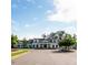 Charming white clubhouse with a clock tower and well-manicured lawn at 208 Regency Ridge Dr, Holly Springs, NC 27540
