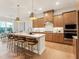 Bright kitchen featuring a large island with bar seating, stainless steel appliances and pendant lighting at 208 Regency Ridge Dr, Holly Springs, NC 27540