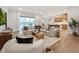 Open concept living room with hardwood floors, a large sectional sofa, and a view to the outdoors at 208 Regency Ridge Dr, Holly Springs, NC 27540