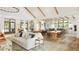 Large common room featuring a fireplace, multiple seating areas, beautiful floors, and plenty of sunlight at 208 Regency Ridge Dr, Holly Springs, NC 27540