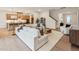 Open concept living room with hardwood floors, kitchen view, and a cozy sitting area by the staircase at 208 Regency Ridge Dr, Holly Springs, NC 27540