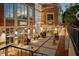 Charming outdoor restaurant patio with string lights, tables, and lively customers enjoying food and games at 208 Regency Ridge Dr, Holly Springs, NC 27540