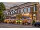 Charming restaurant exterior with outdoor seating and awnings on a tree-lined street at 208 Regency Ridge Dr, Holly Springs, NC 27540
