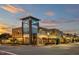 Street view of a town center with shops, restaurants, and modern architecture at dusk at 208 Regency Ridge Dr, Holly Springs, NC 27540