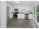 Modern kitchen with stainless steel appliances and white cabinets at 104 Mossbark Ln, Chapel Hill, NC 27514