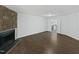 Spacious living room with beautiful hardwood floors and a cozy fireplace and entry to the kitchen at 104 Mossbark Ln, Chapel Hill, NC 27514