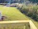 View of a lush backyard with a small stream, captured from the home's deck at 116 Bristow Ct # 49, Four Oaks, NC 27524