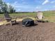 Inviting backyard with Adirondack chairs and covered fire pit, perfect for outdoor relaxation and entertainment at 116 Bristow Ct # 49, Four Oaks, NC 27524