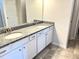 Bathroom features double sinks, granite counters, and white cabinets at 116 Bristow Ct # 49, Four Oaks, NC 27524