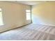 Spacious bedroom with carpeted floors, bright windows, and neutral paint at 116 Bristow Ct # 49, Four Oaks, NC 27524