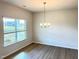 Bright dining room featuring vinyl flooring, a classic chandelier, and abundant natural light at 116 Bristow Ct # 49, Four Oaks, NC 27524