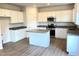Modern kitchen features stainless steel appliances, granite countertops, and white cabinetry at 116 Bristow Ct # 49, Four Oaks, NC 27524
