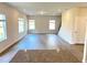 Open-concept living area features modern kitchen, staircase, windows, and vinyl floors at 116 Bristow Ct # 49, Four Oaks, NC 27524