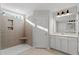 Tiled bathroom featuring a walk-in shower with built-in shelving and white vanity at 125 Bold Dr, Youngsville, NC 27596