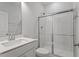 Bathroom showcasing modern vanity, toilet, and shower with glass doors at 125 Bold Dr, Youngsville, NC 27596