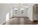 Bright dining room featuring coffered ceilings, a modern chandelier, hardwood floors, and large windows at 125 Bold Dr, Youngsville, NC 27596