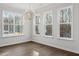 Sunlit dining room with large windows, hardwood flooring, and a modern chandelier, perfect for Gathering gatherings at 125 Bold Dr, Youngsville, NC 27596