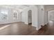 Elegant dining area showcasing hardwood floors, custom cabinetry, arched doorways, and a stylish chandelier at 125 Bold Dr, Youngsville, NC 27596