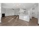 Open-concept living room with hardwood floors, fireplace, and modern chandelier at 125 Bold Dr, Youngsville, NC 27596