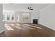 Bright living room with a cozy fireplace, hardwood floors, a ceiling fan, and access to the outdoor patio at 125 Bold Dr, Youngsville, NC 27596
