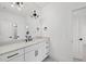 Contemporary bathroom showcasing white cabinetry, matte black hardware, and modern lighting at 4800 Lakemont Dr, Raleigh, NC 27609