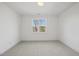 Minimalist bedroom with neutral carpet and a large window providing ample natural light at 4800 Lakemont Dr, Raleigh, NC 27609