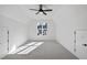 Bright bedroom with a ceiling fan, a large window, carpet flooring, and a neutral color palette at 4800 Lakemont Dr, Raleigh, NC 27609