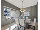 An elegant dining room features paneled walls, modern lighting, and large windows at 4800 Lakemont Dr, Raleigh, NC 27609